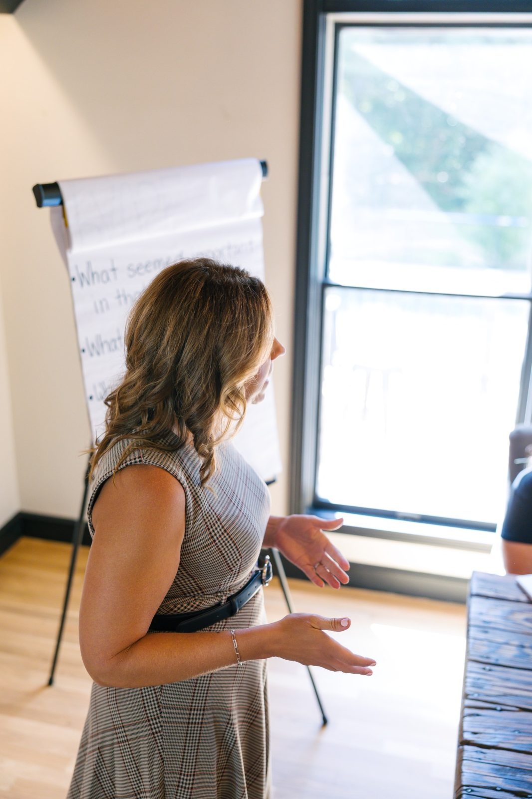 Laura Crosby leading a workshop beside a flip chart