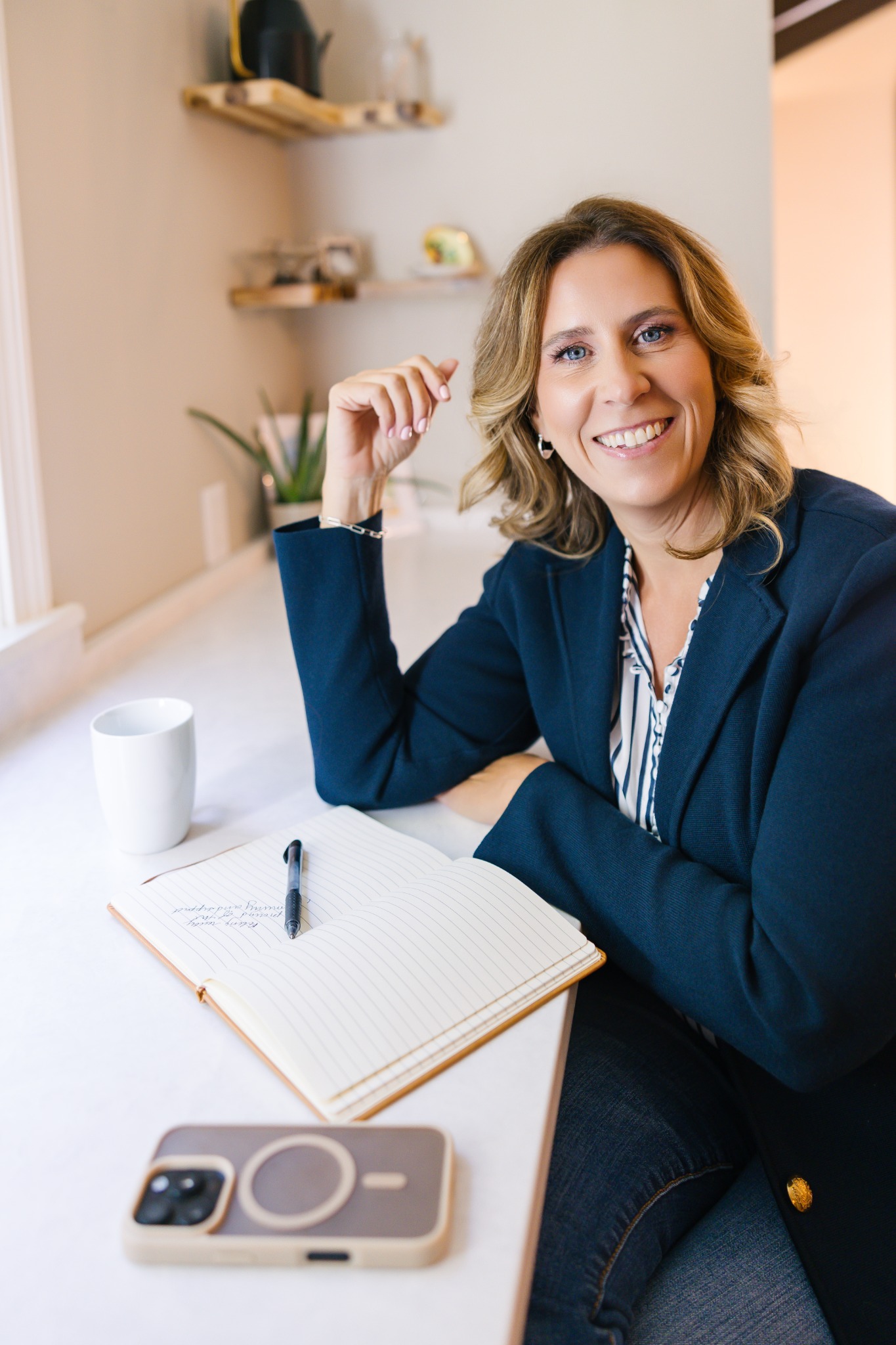 Laura Crosby seated at a desk with an open notebook